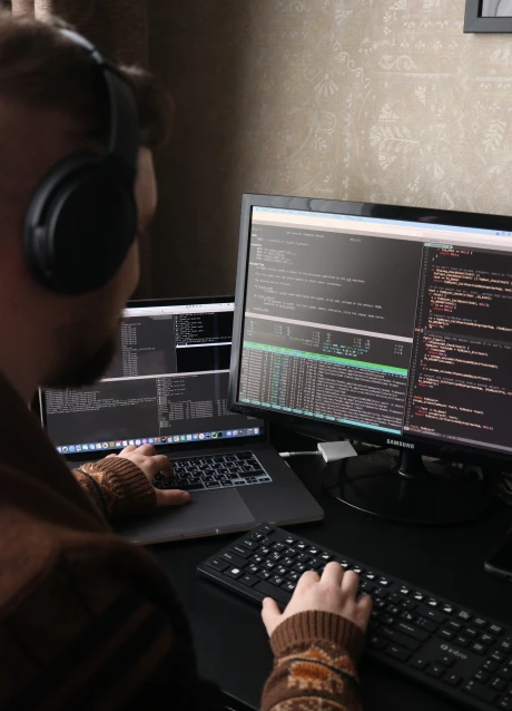 Professional reviewing application data and performance information on a laptop