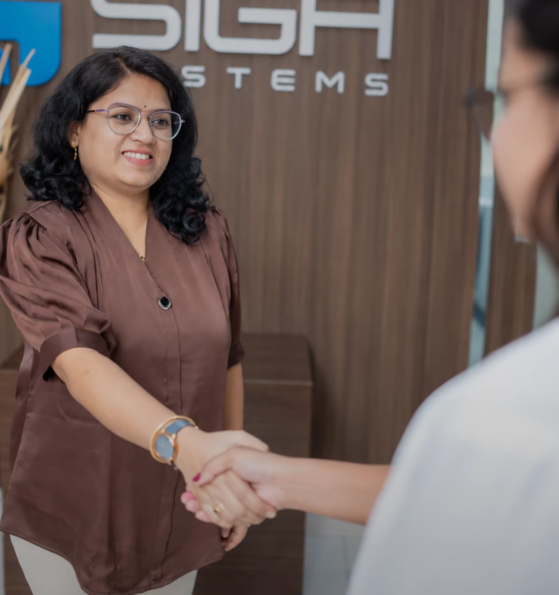 SiGa Systems team member shaking hands with a client