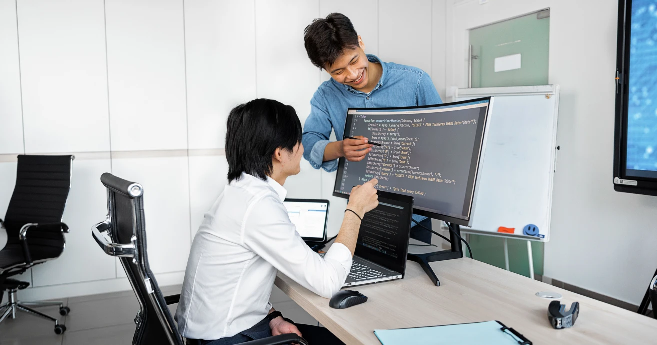 Developer reviewing software with a team member
