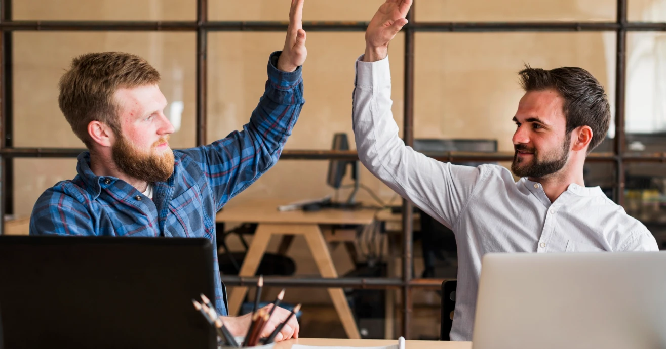 Two developers celebrating a successful collaboration