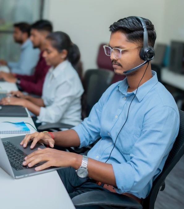Technology professional working at a computer in an office