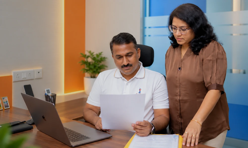 Professionals reviewing information together at a laptop