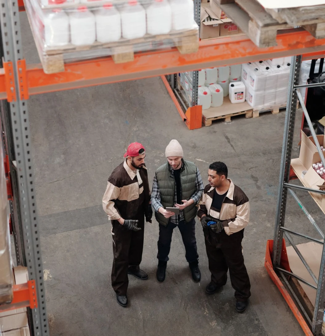 Workers reviewing inventory in a warehouse